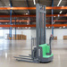 Green and gray forklift on a white background