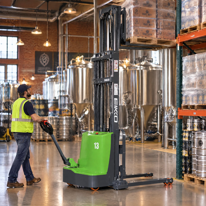 EKKO EB13C-118Li walkie stacker lifting a pallet of beer cases onto an upper rack in a craft brewery